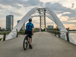 Cyclist prepares to cross bridge