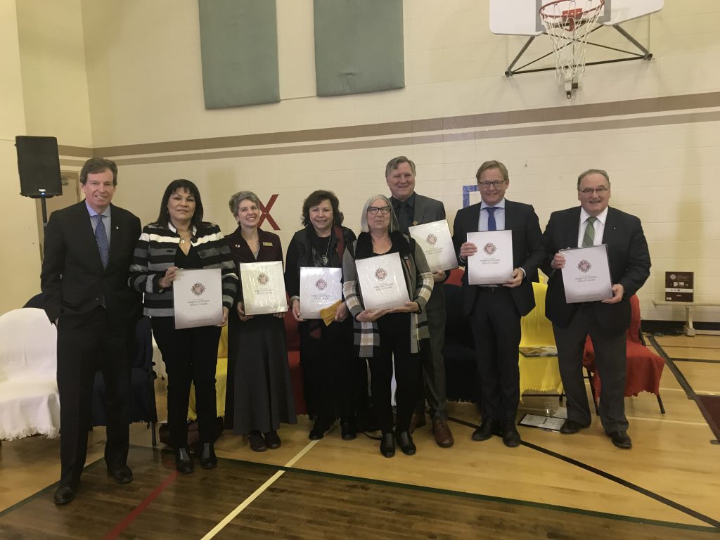 Alberta ministers and leaders stand together holding copies of the Indigenous Peoples Atlas of Canada