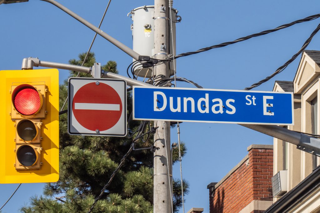 Dundas street sign with stop light and stop sign