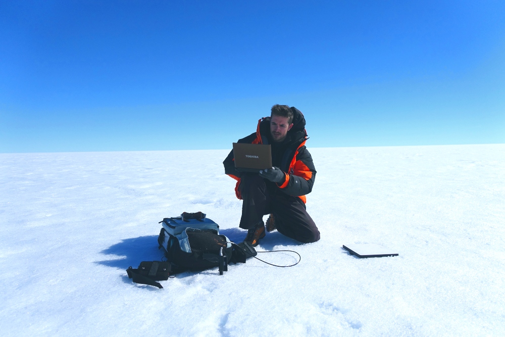 Glaciologist Joseph Cook studies microbial ecosystems on the surface of the Greenland ice sheet.