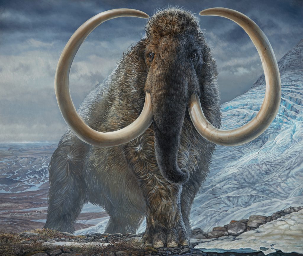 A woolly mammoth with large curling tusks wanders through an icy landscape under billowing grey clouds