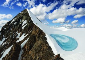 A mountain half covered in snow