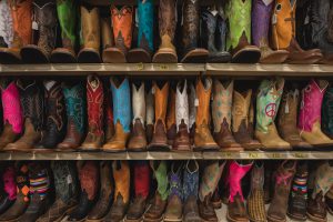 Colourful cowboy boots displayed on shelves in Amarillo Texas by Zach Baranowski