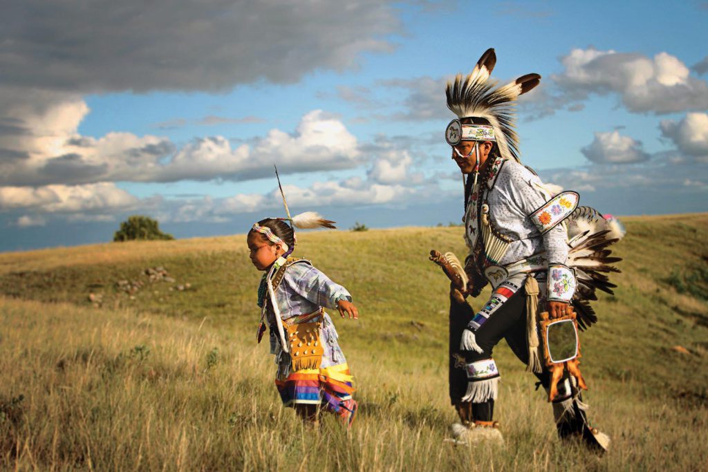 a prairie chicken dancer and his daughter at Wanuskewin Heritage Park