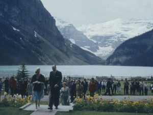The Queen and a man walking with Lake Louise in the background